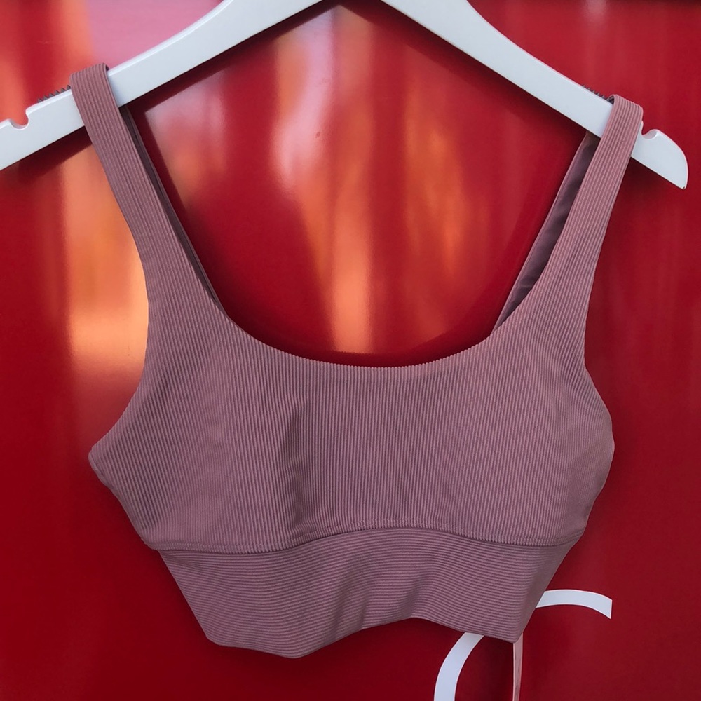 BeachRiot dusty pink ribbed textured sports bra with straight straps.
